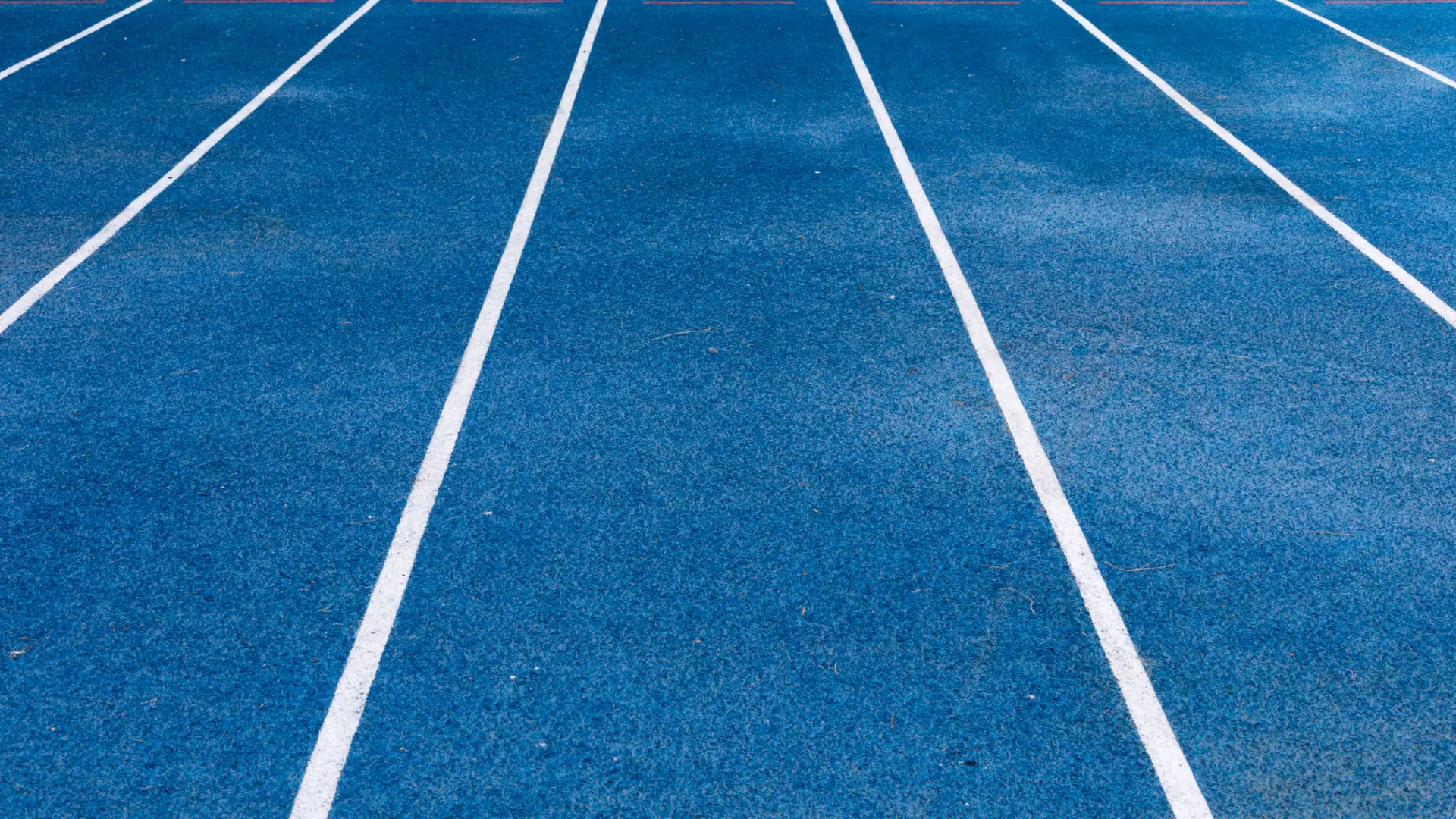 Blue running track with white lane markings